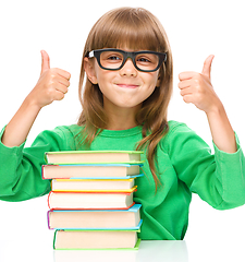 Image showing Little girl is reading a book