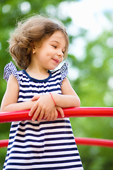 Image showing Cute little girl is playing in playground