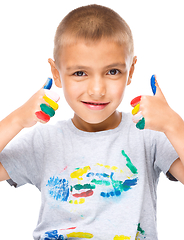 Image showing Portrait of a cute boy playing with paints