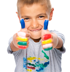 Image showing Portrait of a cute boy playing with paints