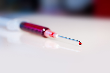 Image showing Syringe needle with blood macro view