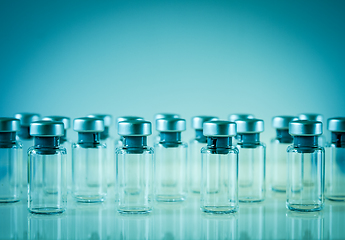 Image showing Vaccine glass bottles on blue background