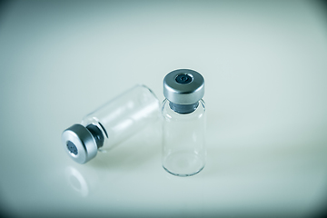 Image showing two vaccine bottles on grey background