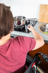 Image showing disabled woman cooking in the kitchen