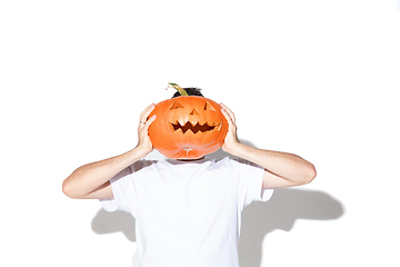 Image showing Young man holding pumpking on white background