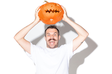 Image showing Young man holding pumpking on white background