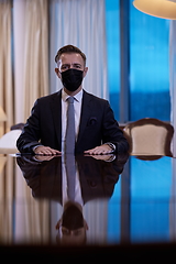 Image showing business man wearing protective face mask at luxury office