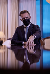 Image showing business man wearing protective face mask at luxury office