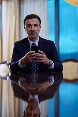 Image showing business man using smart phone at luxury office