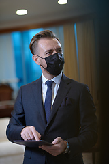 Image showing business man wearing protective face mask at office