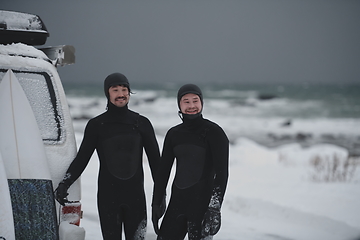 Image showing Arctic surfers in wetsuit after surfing by minivan