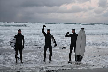 Image showing Arctic surfers going by beach after surfing