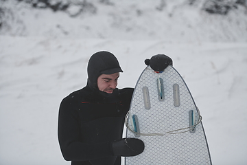 Image showing Arctic surfer portrait holding a board after surfing in Norwegian sea