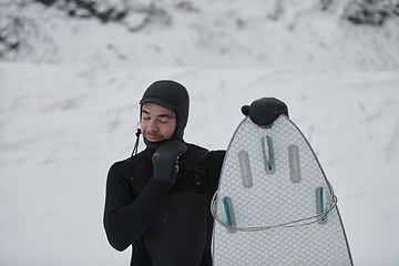 Image showing Arctic surfer portrait holding a board after surfing in Norwegian sea