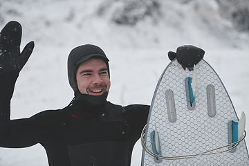 Image showing Arctic surfer portrait holding a board after surfing in Norwegian sea