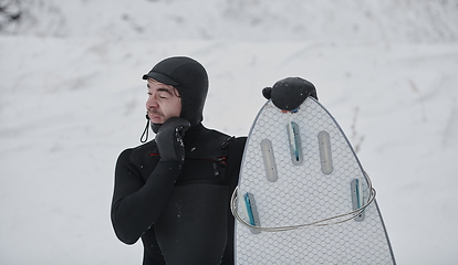 Image showing Arctic surfer portrait holding a board after surfing in Norwegian sea