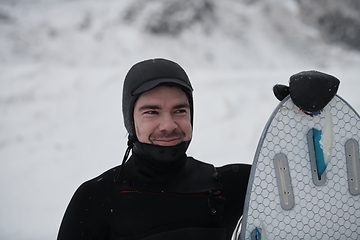 Image showing Arctic surfer portrait holding a board after surfing in Norwegian sea