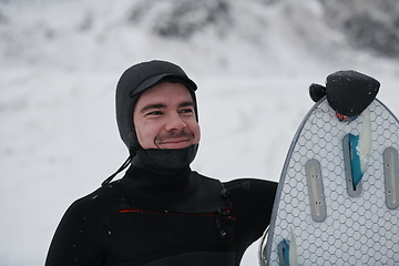 Image showing Arctic surfer portrait holding a board after surfing in Norwegian sea