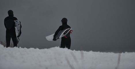 Image showing Arctic surfers running on beach after surfing