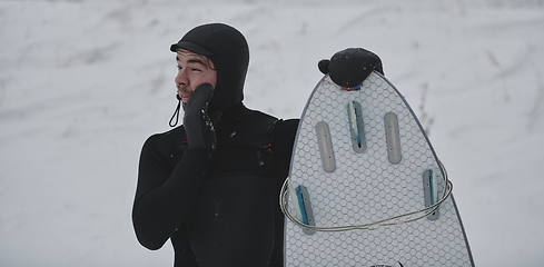 Image showing Arctic surfer portrait holding a board after surfing in Norwegian sea