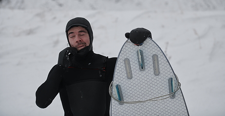 Image showing Arctic surfer portrait holding a board after surfing in Norwegian sea