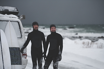 Image showing Arctic surfers in wetsuit after surfing by minivan