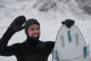 Image showing Arctic surfer portrait holding a board after surfing in Norwegian sea