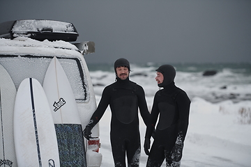 Image showing Arctic surfers in wetsuit after surfing by minivan