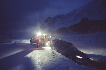 Image showing Car being towed after accident in snow storm