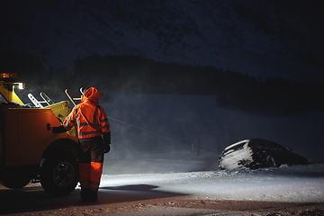 Image showing Car being towed after accident in snow storm