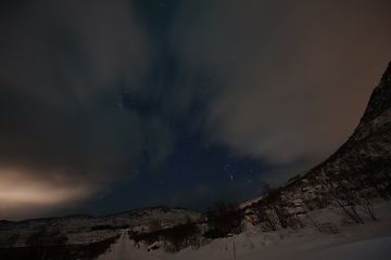 Image showing Aurora borealis Green northern lights above mountains