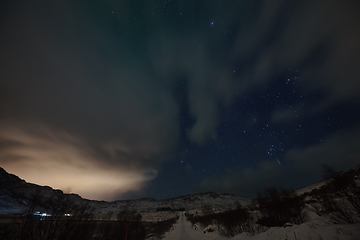 Image showing Aurora borealis Green northern lights above mountains