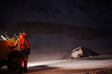 Image showing Car being towed after accident in snow storm