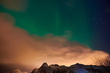 Image showing Aurora borealis Green northern lights above mountains