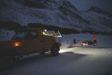 Image showing Car being towed after accident in snow storm