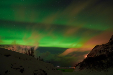 Image showing Aurora borealis Green northern lights above mountains