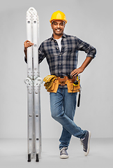 Image showing happy indian builder in helmet with ladder