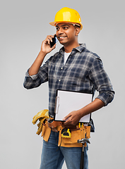 Image showing indian builder in helmet calling on smartphone