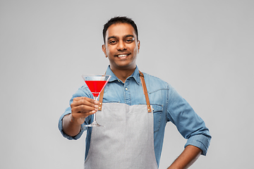 Image showing indian barman in apron with glass of cocktail