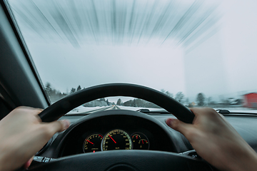 Image showing Riding behind the wheel of a car in winter