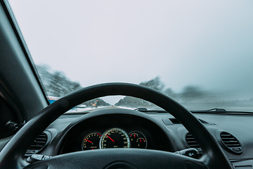 Image showing Riding behind the wheel of a car in winter