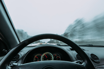 Image showing Riding behind the wheel of a car in winter