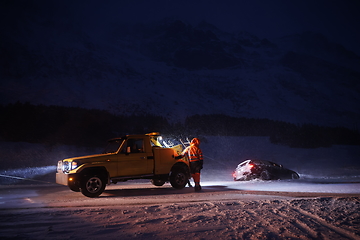 Image showing Car being towed after accident in snow storm