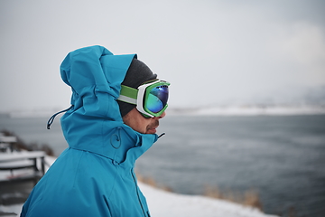 Image showing man at winter in stormy weather night wearing warm fur jacket