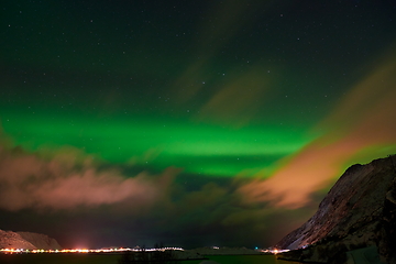 Image showing Aurora borealis Green northern lights above mountains