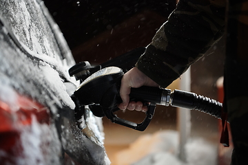 Image showing refuelling diesel gas on petrol station at winter