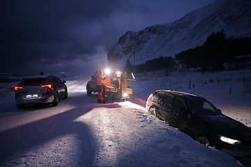 Image showing Car being towed after accident in snow storm