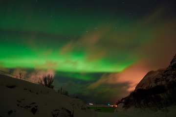 Image showing Aurora borealis Green northern lights above mountains