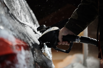 Image showing refuelling diesel gas on petrol station at winter