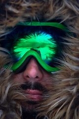 Image showing man at winter in stormy weather wearing warm fur jacket